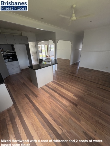 Mixed hardwood with a coat of whitener and 2 coats of water-based satin finish